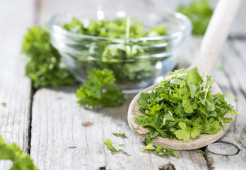 Cutted Parsley on a wooden spoon