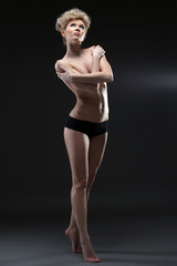 Fototapeta na wymiar Image of lovely half-naked blonde posing in studio