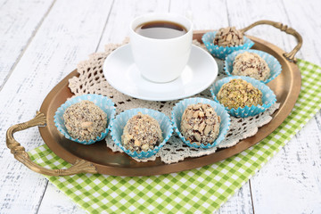 Set of chocolate candies, on tray, on color wooden background