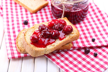 Delicious toast with jam on table close-up