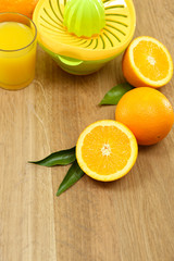 Obraz na płótnie Canvas Citrus press and oranges on wooden background
