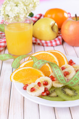 Sweet fresh fruits on plate on table close-up