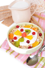 Delicious oatmeal with fruit in bowl on table close-up