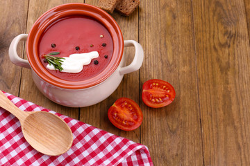 Tasty tomato soup on wooden table