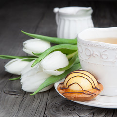Sweet cake with cup of tea on wooden table