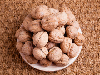 Walnuts on a wooden plate