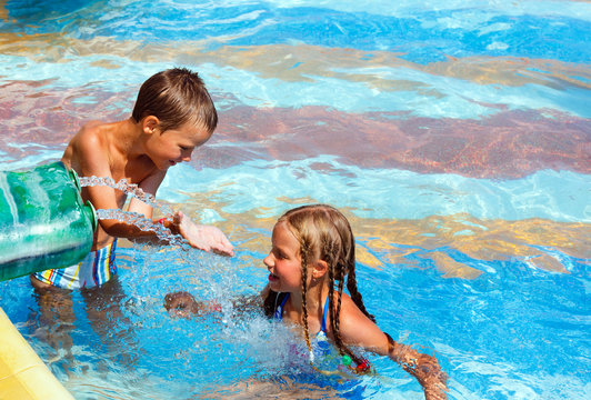 Children in summer outdoor pool.