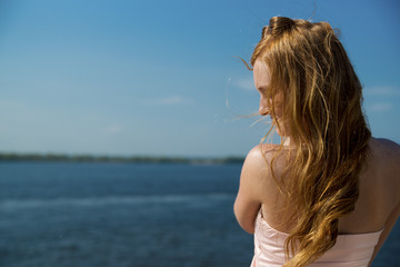 Beautiful young girl on river.