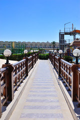 beautiful bridge with wooden railings and lamps