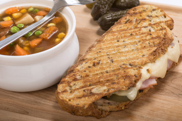 Delicious ham, pork and swiss cheese panini with vegetable soup