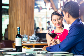 Asian couple fine dining in restaurant
