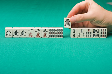 Smooth table surface with a majhong on it