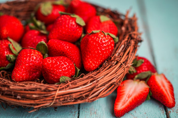 Strawberries in the basket on wooden background