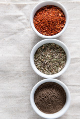 spices in bowls on white tablecloth