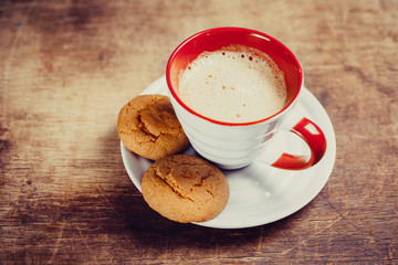 Coffee and  biscuits on wooden board