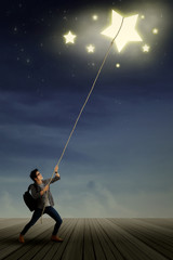 Male student pulling stars