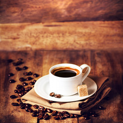 Coffee cup and roasted coffee beans  on wooden  brown background