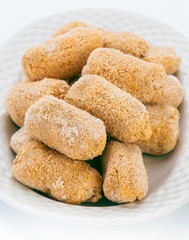 frozen croquettes, before cooking, in white tray