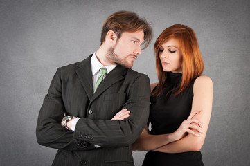 Angry couple studio portrait against grunge background.