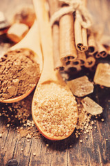 Brown sugar and cocoa powder on  wooden background