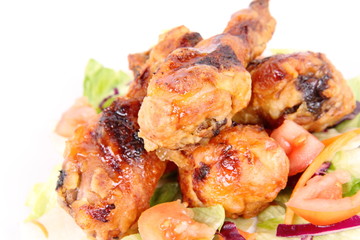 Fried chicken legs with side salad decorated with basil