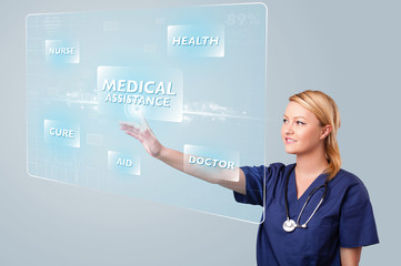 Young nurse pressing modern medical type of buttons