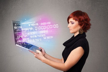 Casual woman holding laptop with exploding data and numers