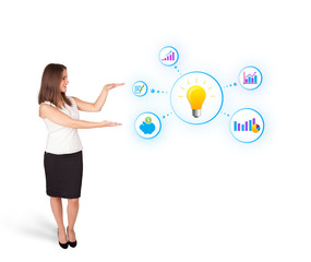 Young woman presenting light bulb with colorful graphs and diagr