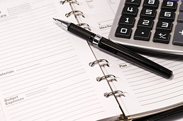 note pad with pen and calculator