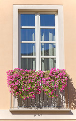 Old italian balcony with flowers.