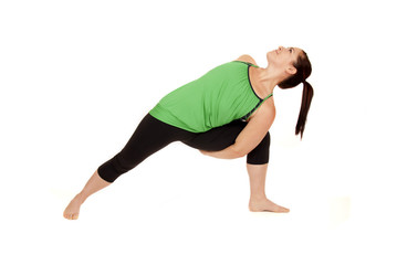 woman doing yoga pose called revolved extended side angle