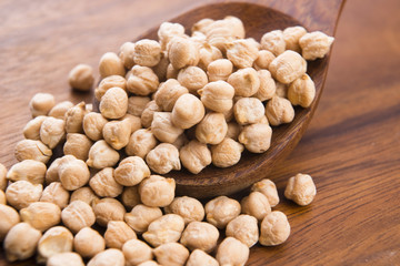 dried white chickpeas ceci on the wooden spoon