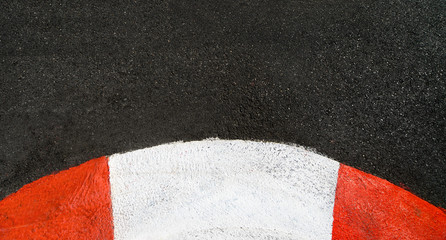 Texture of race asphalt and curved curb Grand Prix circuit