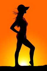 silhouette woman in a hat with hair blowing