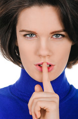 Naklejka premium young woman shows sign and symbol on white background
