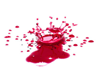 Glossy red liquid droplets (splatters) isolated on white