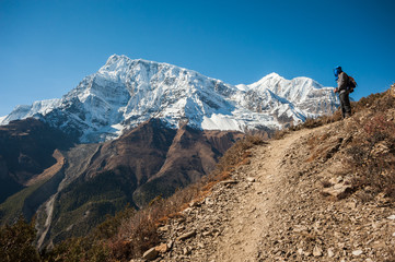 Trekker and Annapurna range, Himalayas of Nepal.