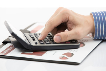 Fototapeta premium Male hand with pen analyzing financial data
