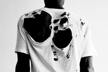 man's back with a ripped t-shirt