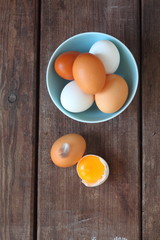 white and brown chicken eggs on a brown table
