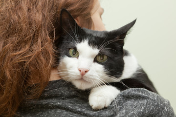 beautiful young woman with monochrome black and white cat