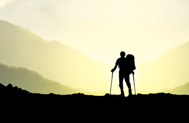 Silhouette of tourist in mountains. Sport and active life