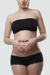 Woman holding her pregnant belly. White background.