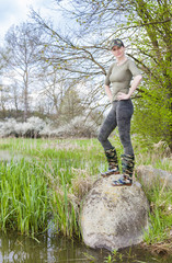 woman wearing rubber boots in spring nature