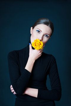 Beautiful Woman With Yellow Rose Flower In Her Mouth