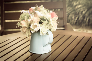 Artificial flowers in metal vase,vintage style light.