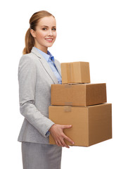smiling businesswoman holding cardboard boxes