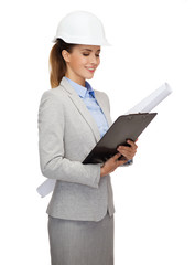 smiling architect in white helmet with blueprints