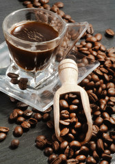 coffe cup with coffee beans and wood spoon