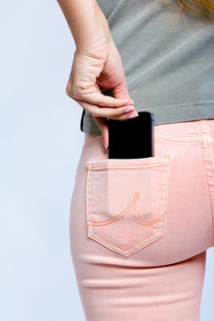 Black smartphone in back pocket of girl's jeans